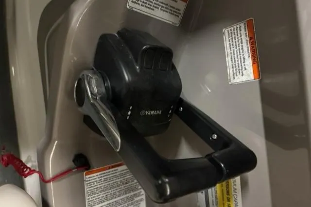 Slide: The Image of Yamaha SX230 2007 boat throttle control with safety warnings and red lanyard. - 10