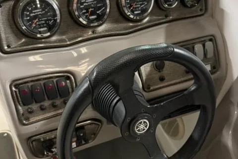 Slide: The Image of Steering wheel and dashboard of 2007 Yamaha SX230 boat with gauges and controls. - 12