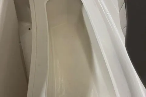 Slide: The Image of 2007 Yamaha Boats SX230 interior storage compartment, white and spacious. - 19