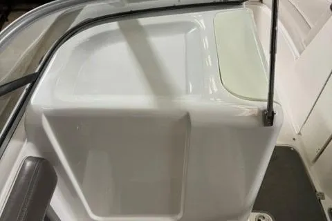 Slide: The Image of 2007 Yamaha Boats SX230 interior detail, featuring sleek white design and seating area. - 21