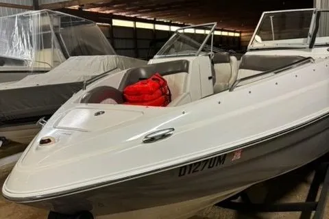 Slide: The Image of 2007 Yamaha Boats SX230 in storage, featuring sleek design and red life jackets. - 7