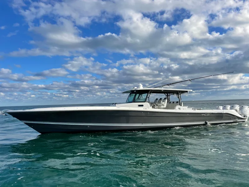 Slide: The Image of 2019 HCB 53 Sueños boat cruising on open water under a cloudy sky. - 1