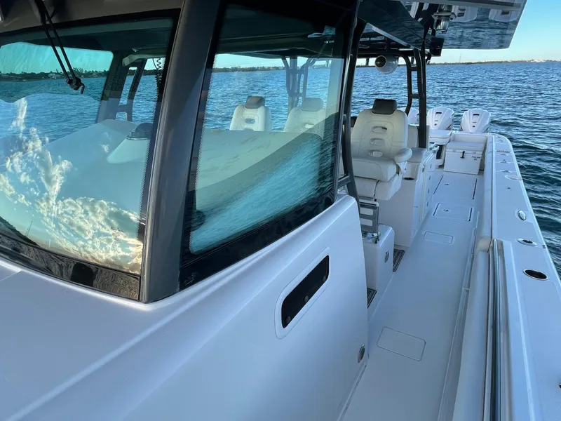 Slide: The Image of 2019 HCB 53 Sueños boat on water, showcasing sleek design and spacious seating. - 13