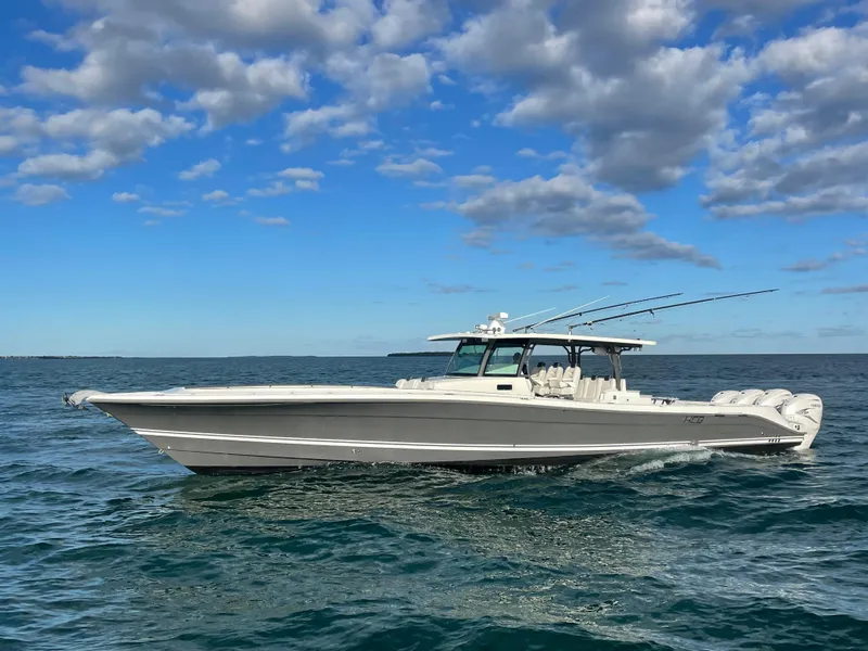 Slide: The Image of 2019 HCB 53 Sueños boat cruising on open water under a partly cloudy sky. - 3