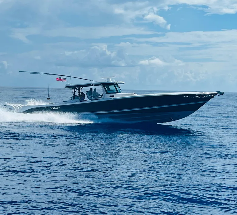 Slide: The Image of 2019 HCB 53 Sueños boat cruising on open water under a cloudy sky. - 4