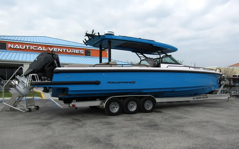 Slide: The Image of 2024 Axopar 37 Sun Top boat on trailer at Nautical Ventures. - 1