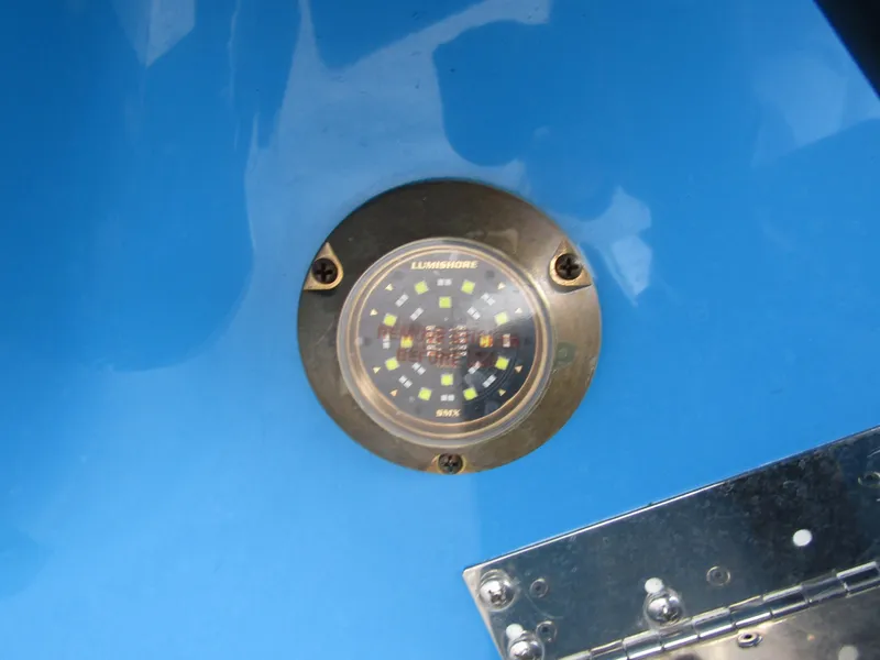 Slide: The Image of 2024 Axopar 37 Sun Top boat with a blue hull and underwater LED light. - 11