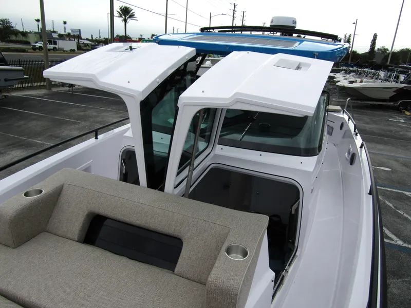 Slide: The Image of 2024 Axopar 37 Sun Top boat with open roof and seating area. - 17