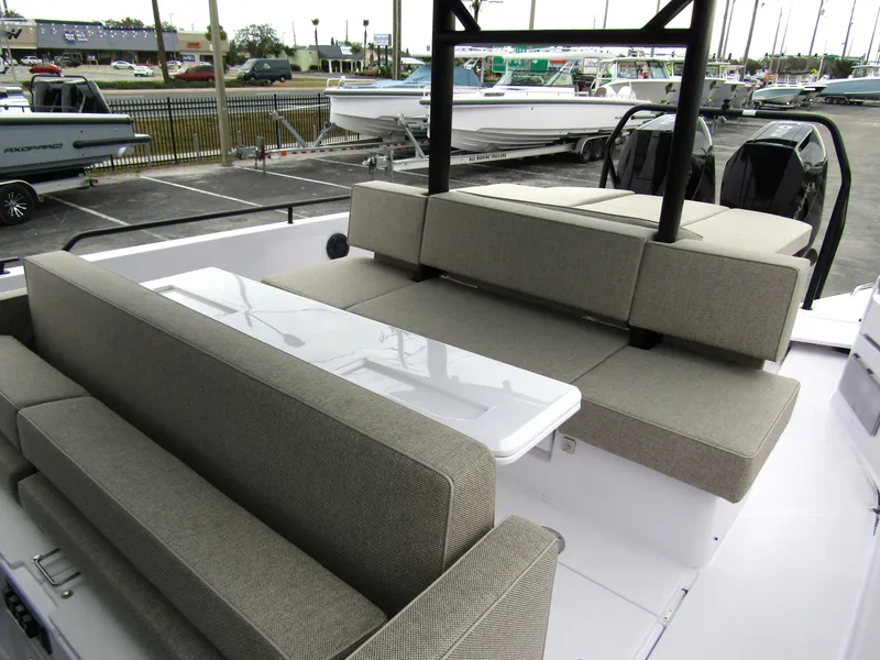 Slide: The Image of 2024 Axopar 37 Sun Top boat with spacious seating and sleek design. - 19