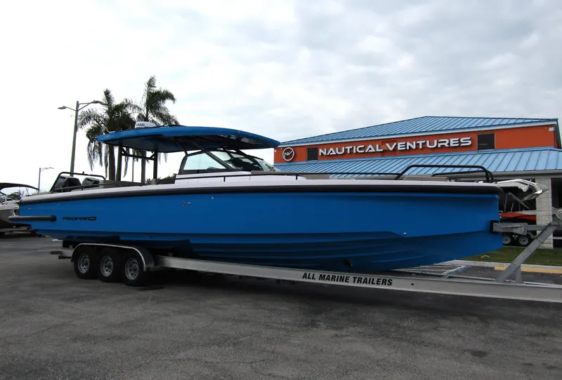 Slide: The Image of 2024 Axopar 37 Sun Top boat on trailer at Nautical Ventures dealership. - 2