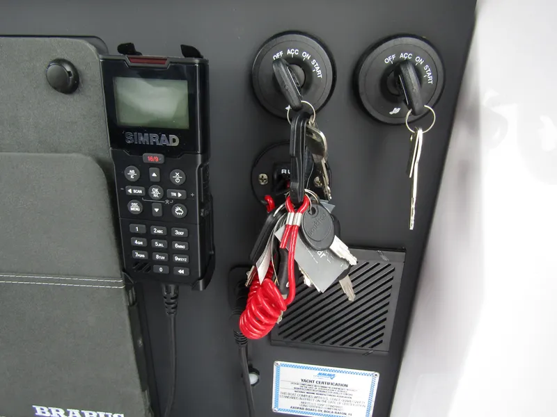 Slide: The Image of Control panel with keys and SIMRAD device on 2024 Axopar 37 Sun Top boat. - 27
