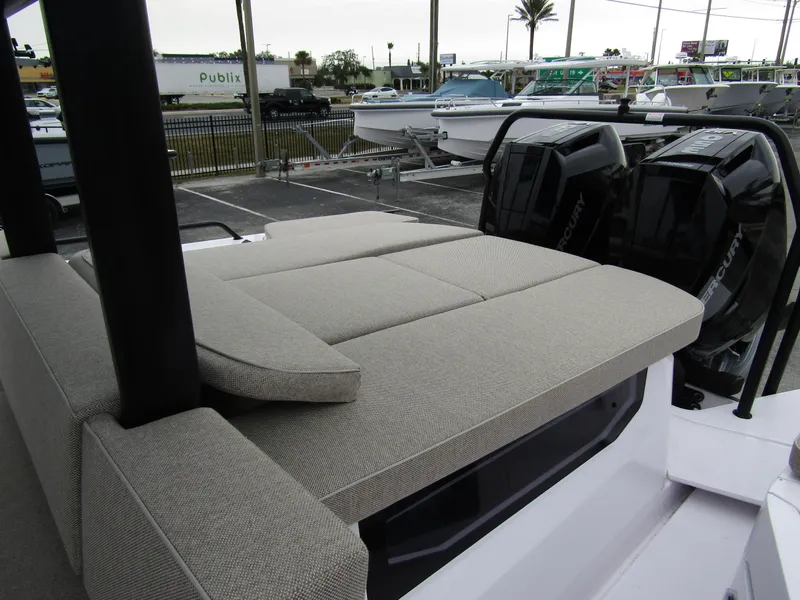 Slide: The Image of 2024 Axopar 37 Sun Top with cushioned seating and dual Mercury outboard engines. - 34