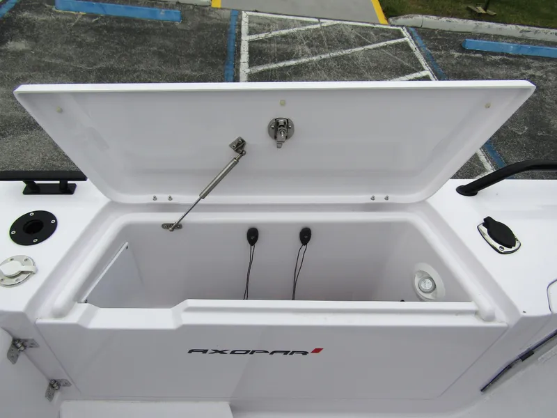 Slide: The Image of 2024 Axopar 37 Sun Top storage compartment with open lid, showcasing interior features. - 37