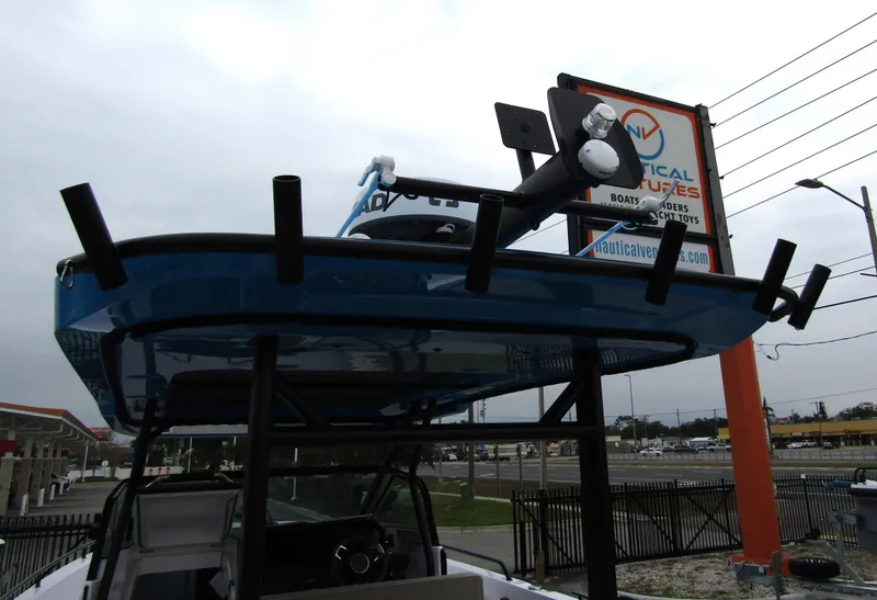 Slide: The Image of 2024 Axopar 37 Sun Top boat displayed at Nautical Ventures dealership. - 38