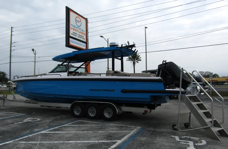 Slide: The Image of 2024 Axopar 37 Sun Top boat on trailer at dealership parking lot. - 4