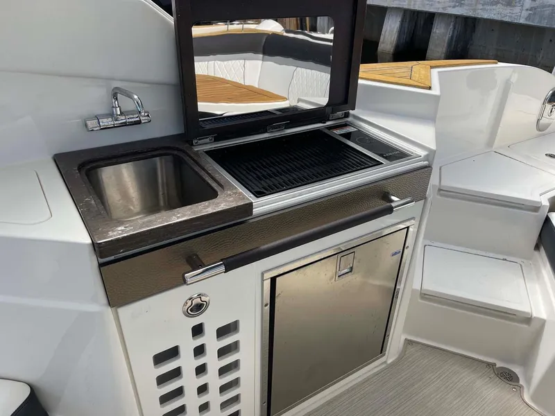 Slide: The Image of Outdoor kitchen on 2018 Sea Ray 350 SLX boat with sink and grill. - 13