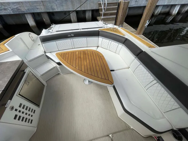Slide: The Image of 2018 Sea Ray 350 SLX boat interior with elegant seating and wooden table. - 14