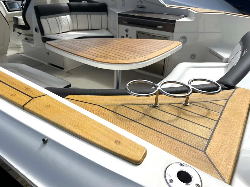 Slide: The Image of 2018 Sea Ray 350 SLX interior with wood accents and seating area. - 15