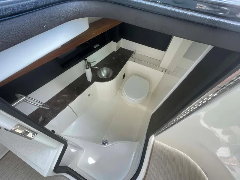 Slide: The Image of 2018 Sea Ray 350 SLX boat interior bathroom with sink and toilet. - 16