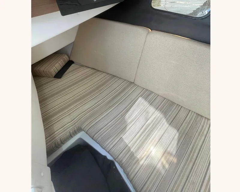 Slide: The Image of Interior cabin of 2018 Sea Ray 350 SLX with striped upholstery and window view. - 17