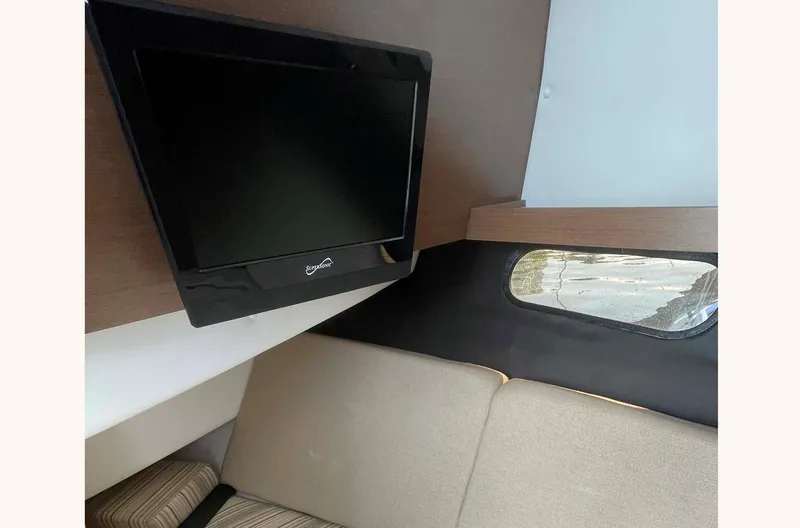 Slide: The Image of Interior of 2018 Sea Ray 350 SLX with TV and seating area. - 18
