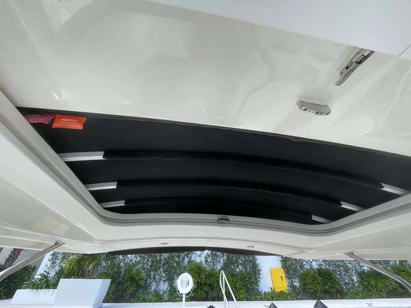 Slide: The Image of 2018 Sea Ray 350 SLX boat interior roof view with open sunroof. - 20