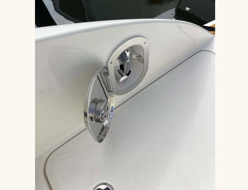 Slide: The Image of 2018 Sea Ray 350 SLX boat detail, chrome fixture on white surface. - 21