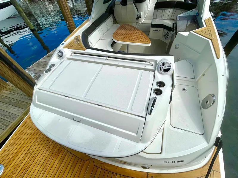Slide: The Image of 2018 Sea Ray 350 SLX boat with spacious seating and sleek design at dock. - 23