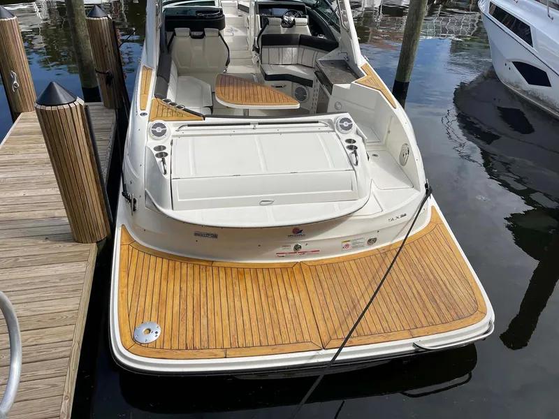 Slide: The Image of 2018 Sea Ray 350 SLX boat docked, featuring spacious teak swim platform. - 24
