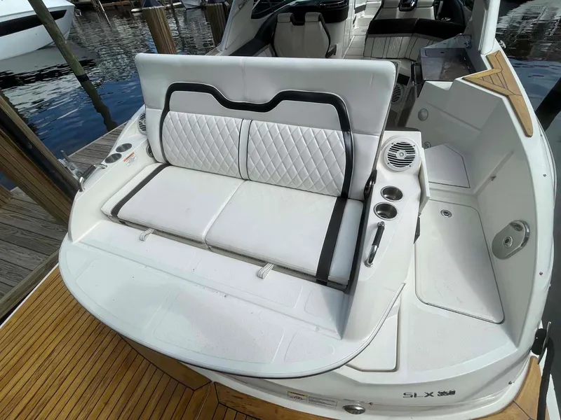 Slide: The Image of 2018 Sea Ray 350 SLX boat with white leather seating and cup holders. - 25