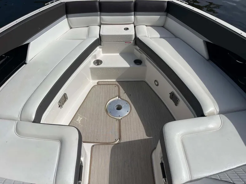 Slide: The Image of 2018 Sea Ray 350 SLX boat interior with white seating and cup holders. - 3