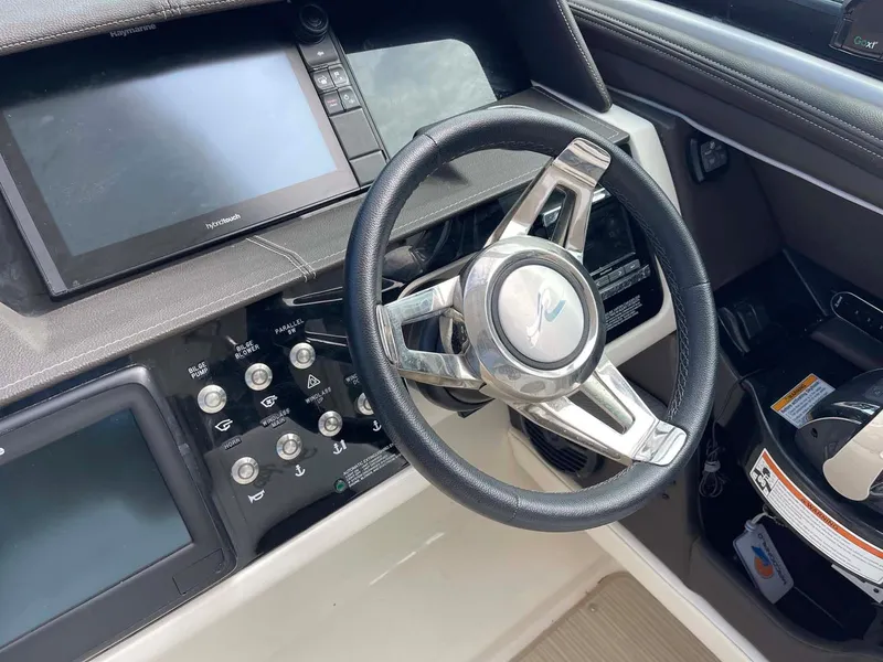 Slide: The Image of 2018 Sea Ray 350 SLX boat dashboard with steering wheel and control panel. - 5