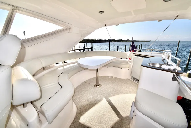 Slide: The Image of Luxurious 2010 Neptunus 58 yacht interior with white seating and ocean view. - 25