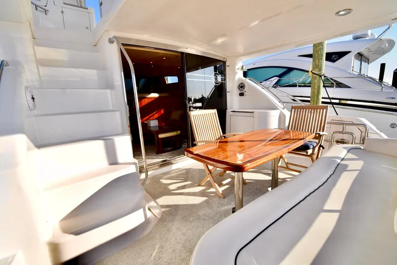 Slide: The Image of Luxurious 2010 Neptunus 58 yacht deck with seating and dining area. - 28