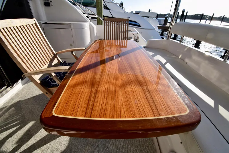Slide: The Image of Luxurious Neptunus 58 yacht deck with polished wooden table and chairs, 2010 model. - 30