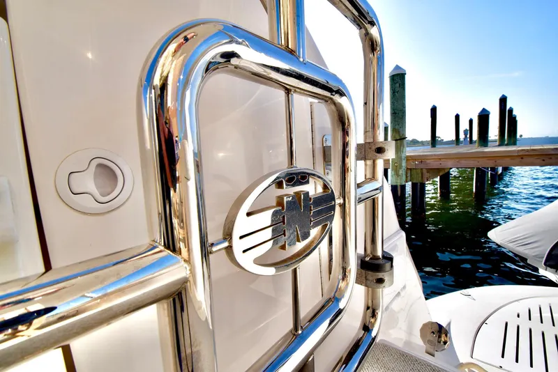 Slide: The Image of Close-up of 2010 Neptunus 58 yacht railing with logo, docked by the water. - 31
