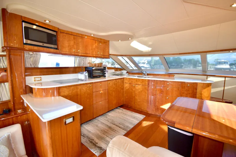 Slide: The Image of Luxurious Neptunus 58 yacht kitchen interior with wood cabinetry and modern appliances, 2010 model. - 7
