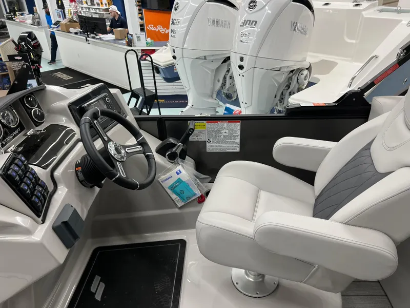 Slide: The Image of 2024 Starcraft SLS 5 Q DH boat interior with steering wheel and comfortable seating. - 5