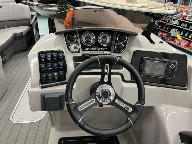Slide: The Image of 2024 Starcraft SLS 5 Q DH boat dashboard with steering wheel and control panel. - 6
