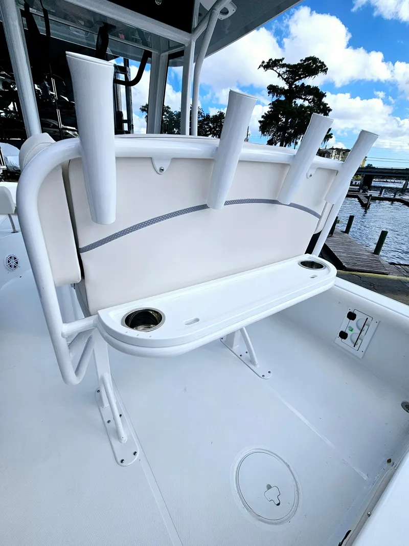 Slide: The Image of 2025 Sea Hunt BX 25 FS boat with rod holders and seating, dockside view. - 10