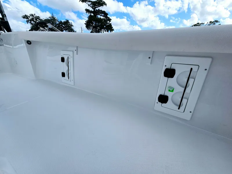 Slide: The Image of 2025 Sea Hunt BX 25 FS boat interior with storage compartments, white finish, and clear sky background. - 11