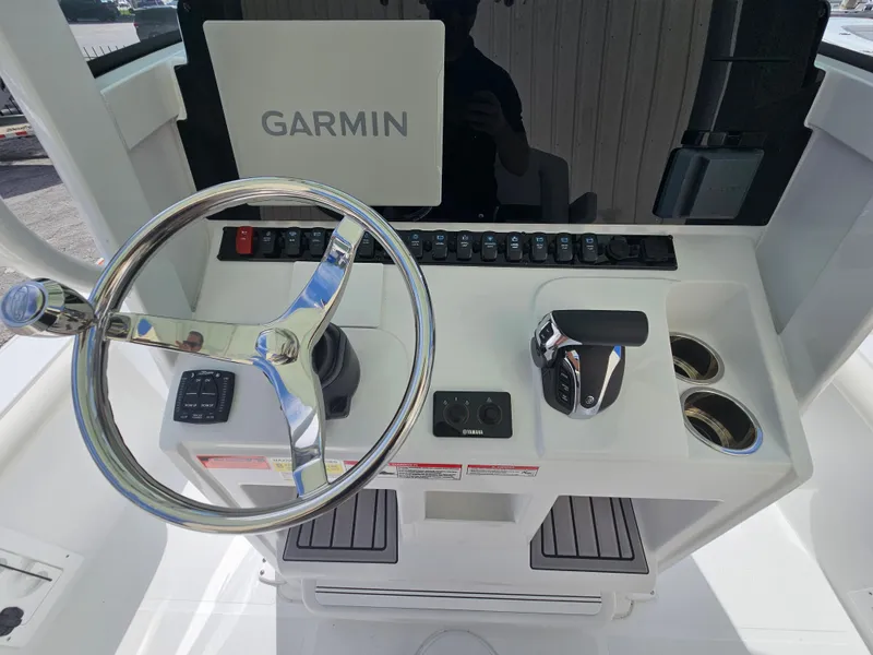 Slide: The Image of 2025 Sea Hunt BX 25 FS boat console with Garmin navigation and steering wheel. - 15