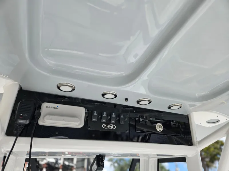 Slide: The Image of 2025 Sea Hunt BX 25 FS boat console with Garmin device and controls. - 16