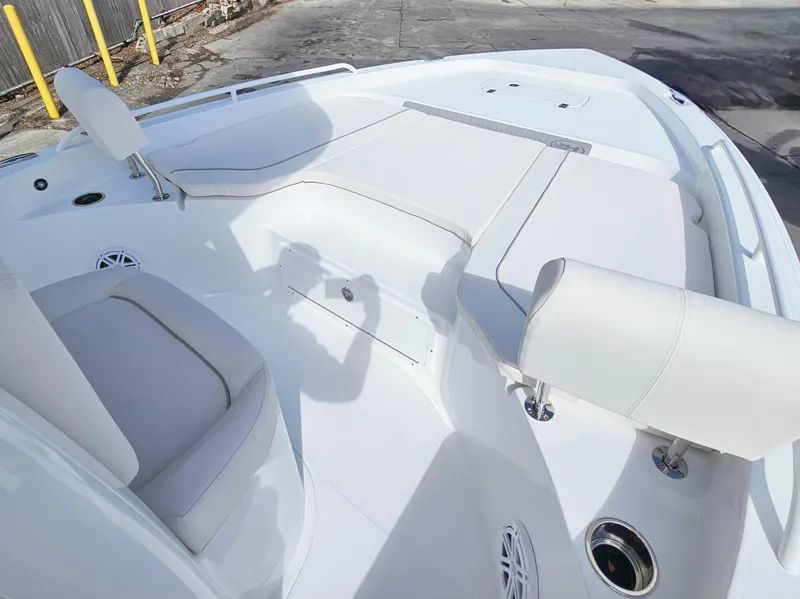 Slide: The Image of 2025 Sea Hunt BX 25 FS boat interior with white seating and storage compartments. - 17