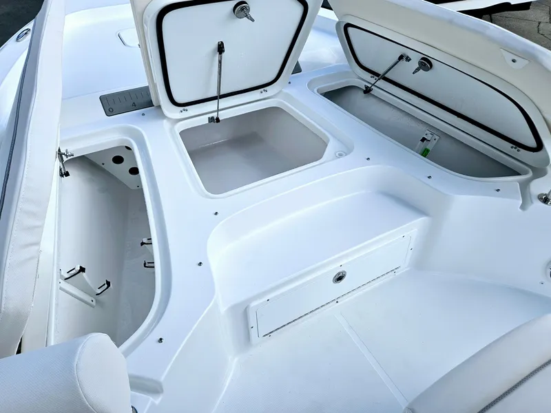Slide: The Image of 2025 Sea Hunt BX 25 FS boat storage compartments open, showcasing spacious design. - 19
