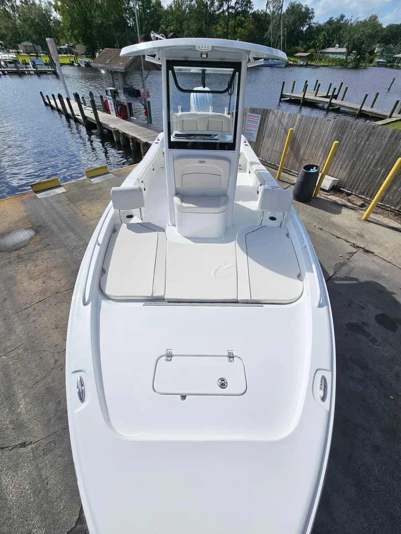 Slide: The Image of 2025 Sea Hunt BX 25 FS boat at dock, sleek design, spacious deck. - 22