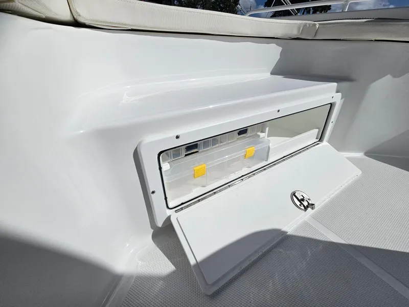 Slide: The Image of 2025 Sea Hunt BX 25 FS boat storage compartment with open hatch. - 25