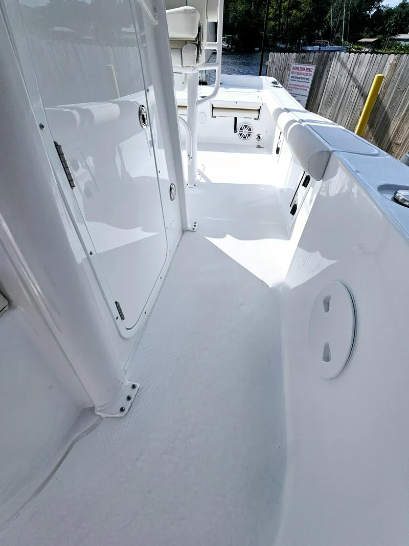 Slide: The Image of 2025 Sea Hunt BX 25 FS boat interior, featuring sleek white deck and storage compartments. - 28