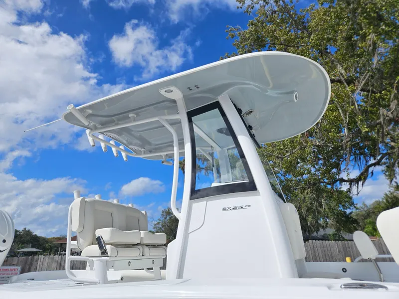Slide: The Image of 2025 Sea Hunt BX 25 FS boat with T-top under a clear blue sky. - 3
