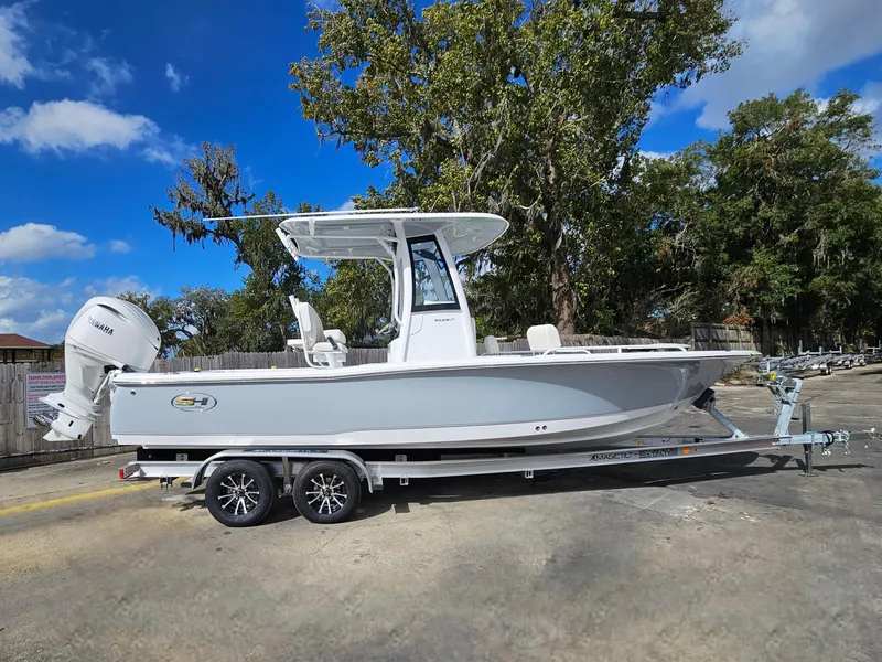 Slide: The Image of 2025 Sea Hunt BX 25 FS boat on trailer, parked outdoors under blue sky. - 4